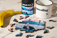 Art by Di Rise Mini Wood Jigsaw Puzzle featuring colorful, interlocking wooden pieces on a white background.