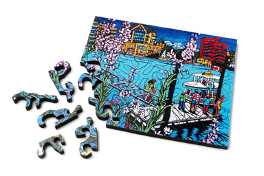 Mini wood jigsaw puzzle by Diane Adolph featuring a colorful pickle boat design, perfect for puzzle enthusiasts.