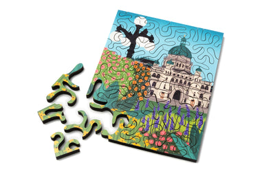 Mini wood jigsaw puzzle from Garden City collection by Sharon Lam, featuring colorful cityscape artwork.