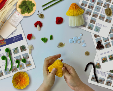 Hands Craft DIY Chenille Kit for Mushroom House, showing colorful felt pieces and craft materials for creating a mushroom-themed project.